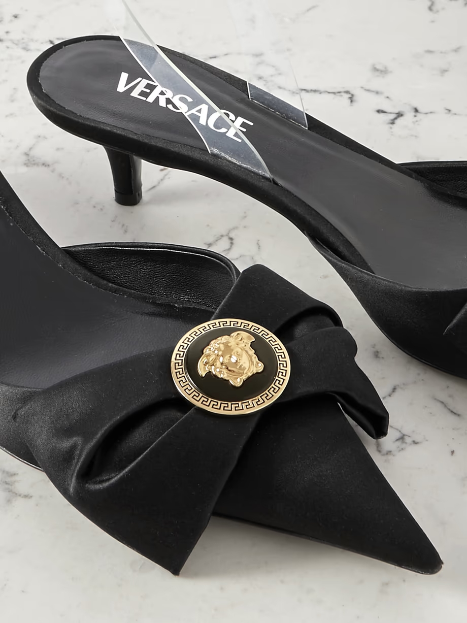 Medusa bow embellished rubber-trimmed satin slingback pumps